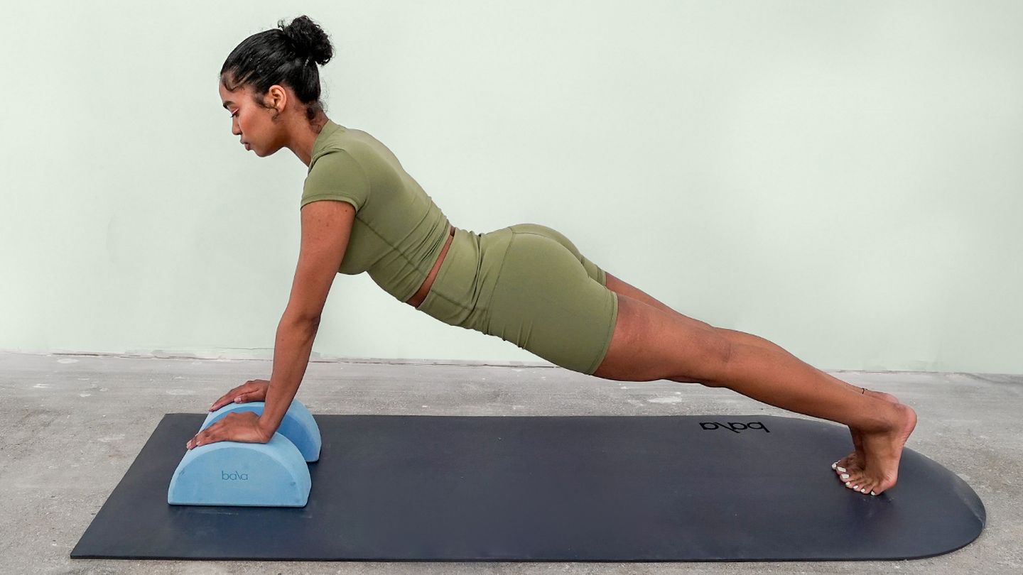 Woman using a Bala product to exercise